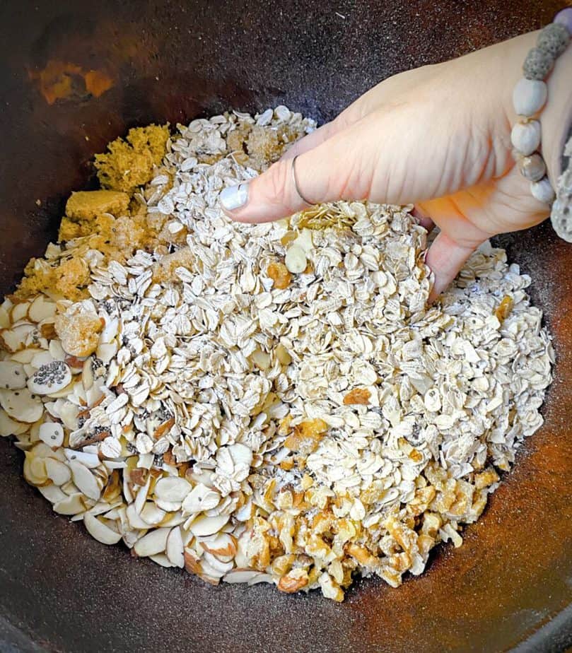 hand mixing homemade granola dry ingredients