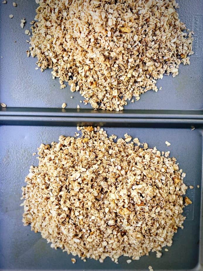 unbaked granola split between two half sheet pans