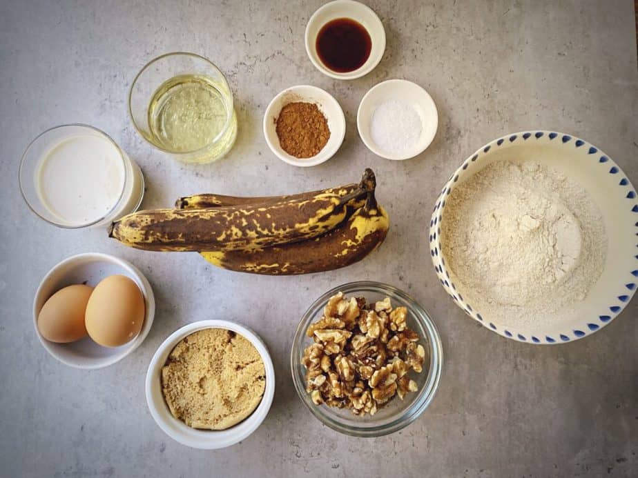 ingredients for maple walnut banana bread baked donuts measured out into bowls.