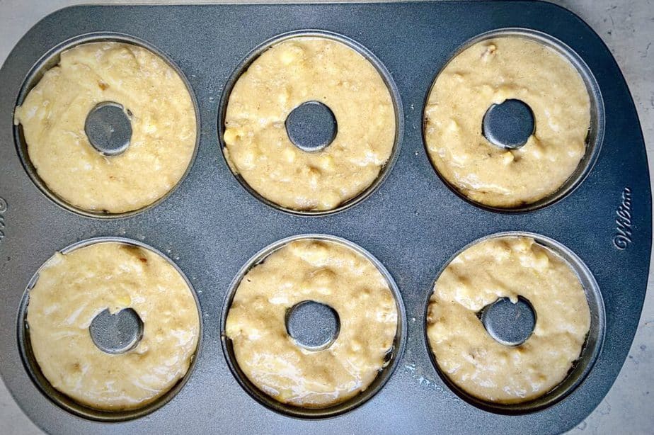 banana bread donut batter in donut pan prior to baking.