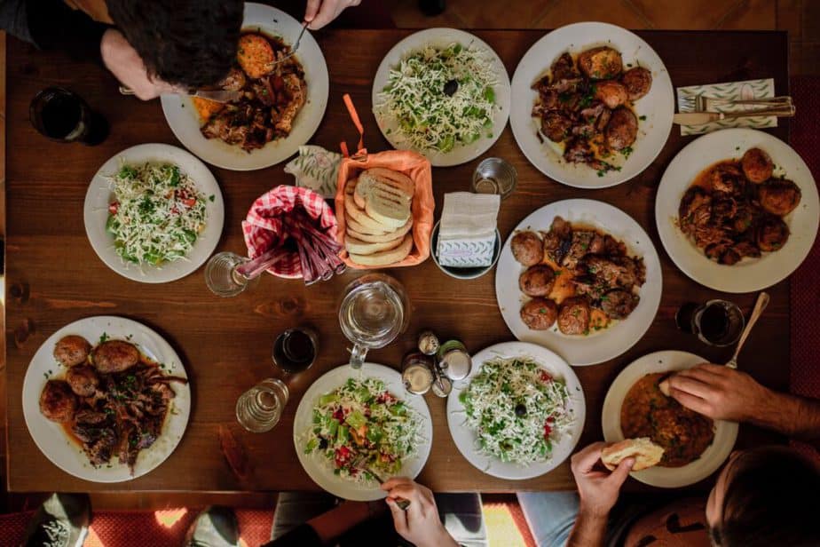 overhead shot of people eating a huge holiday feast.