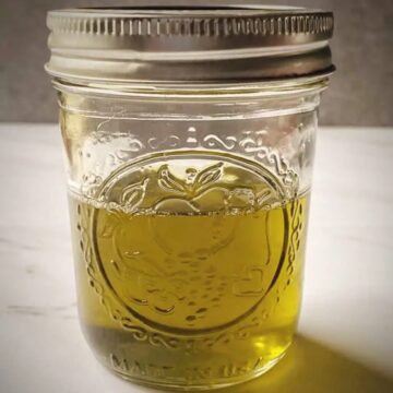small mason jar filled with completed cbd oil cannabutter
