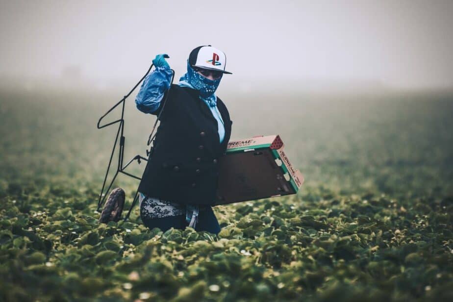farm worker in the field is covered with protective gear. 