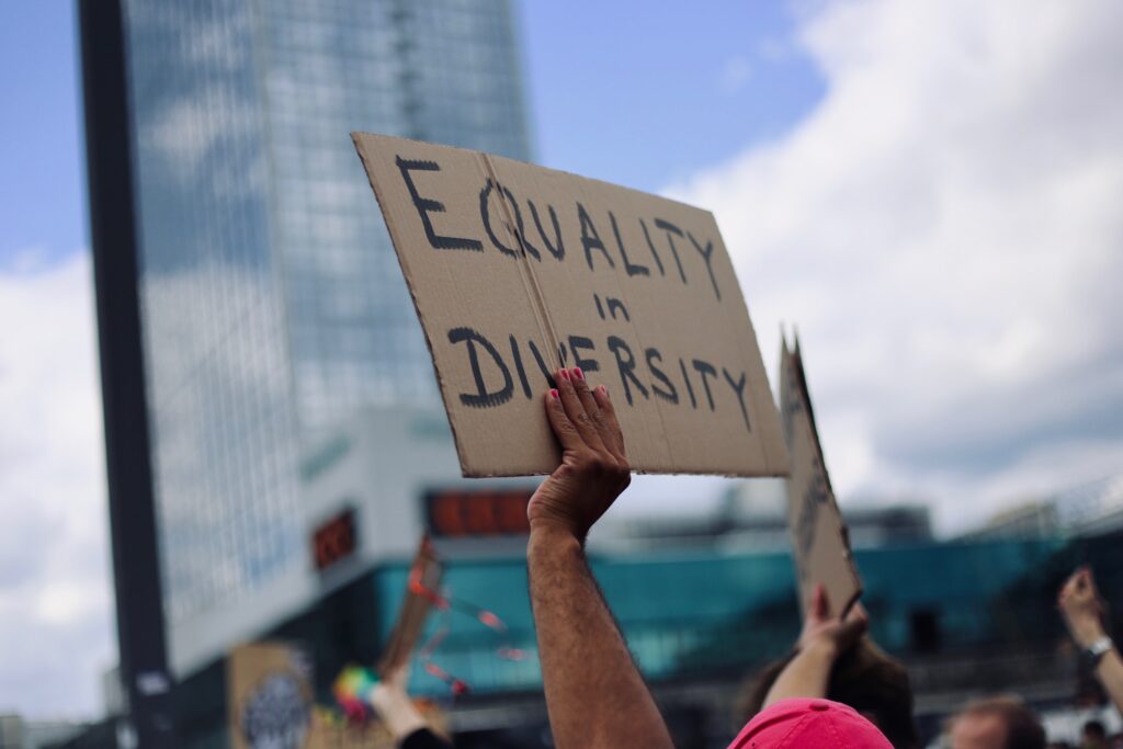 hand holding sign that says "equality in diversity."