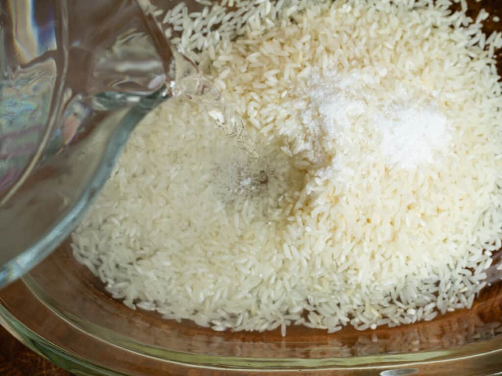 adding hot water to rice.