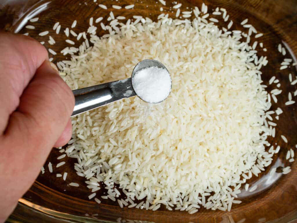 adding salt to rice.