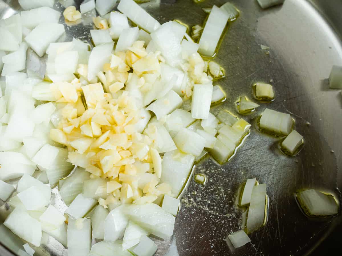 sautéing onions and garlic for making turmeric rice.