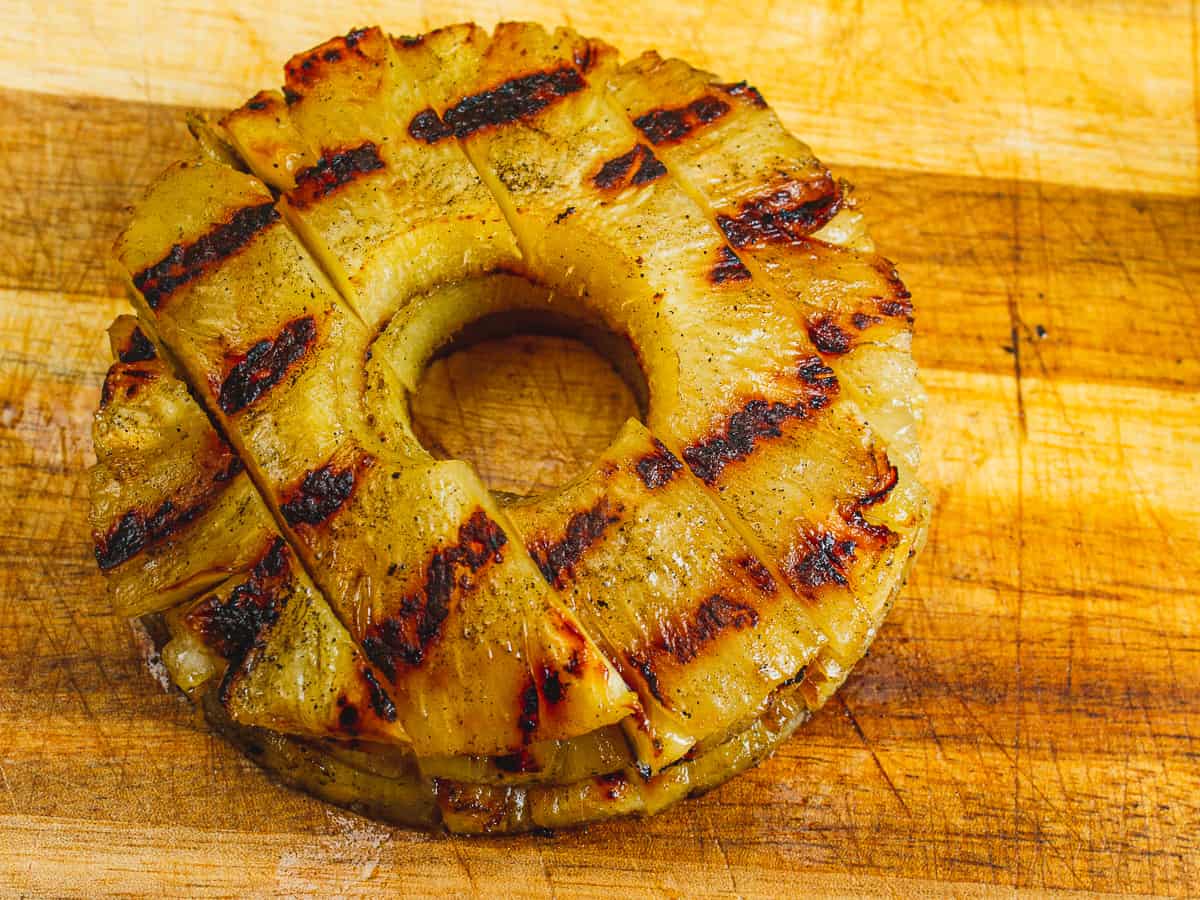 grilled pineapple rings after being sliced for putting on pork sliders.