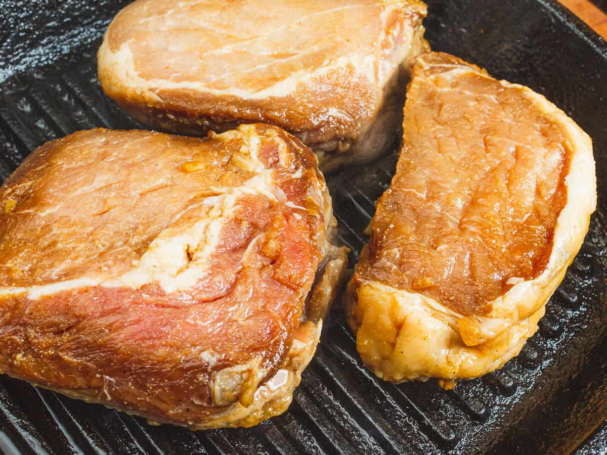 pork chops on a grill.