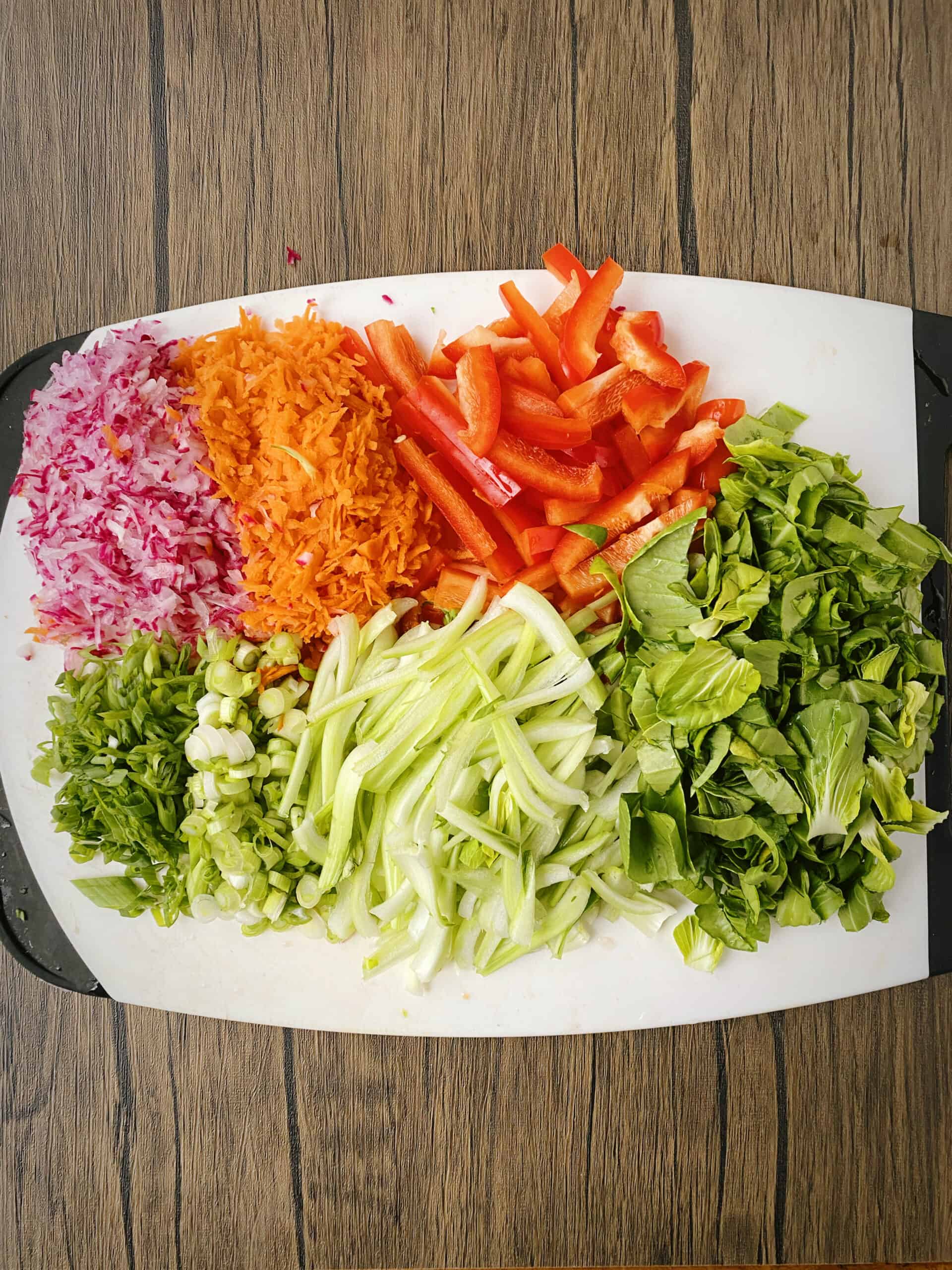 prepped veggies on a white cutting board.