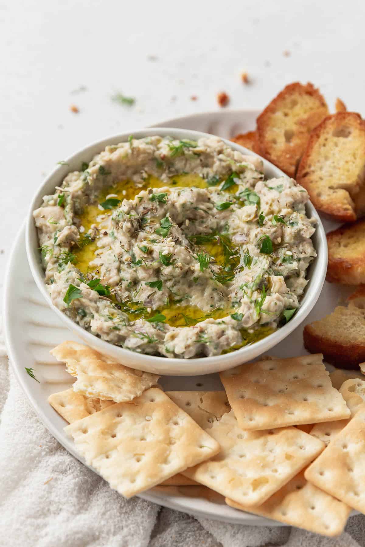 vertical hero of a serving platter of healthy tuna and white bean dip with no sour cream.