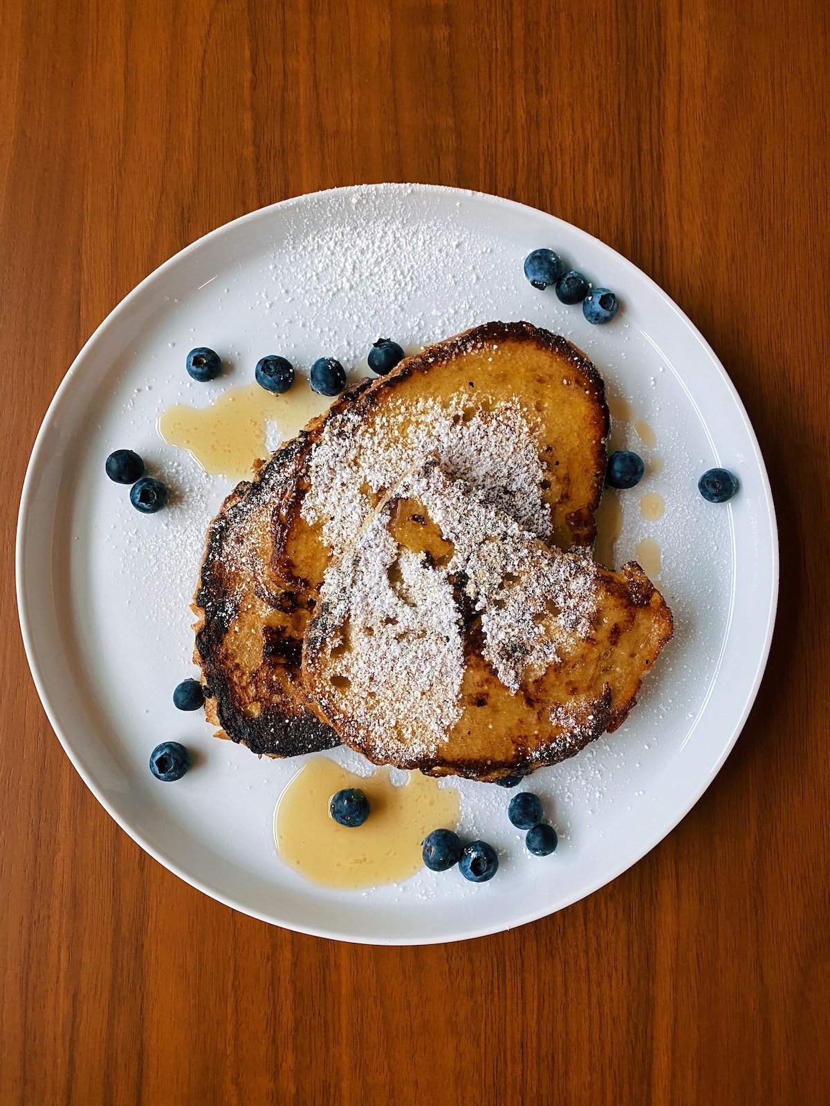 no egg french toast on a white plate with blueberries.