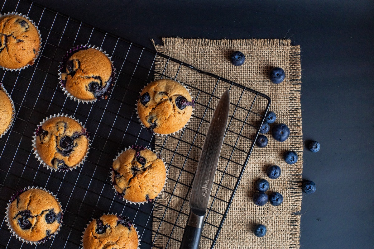 a cooling rack with blueberry muffins made with egg substitutes.