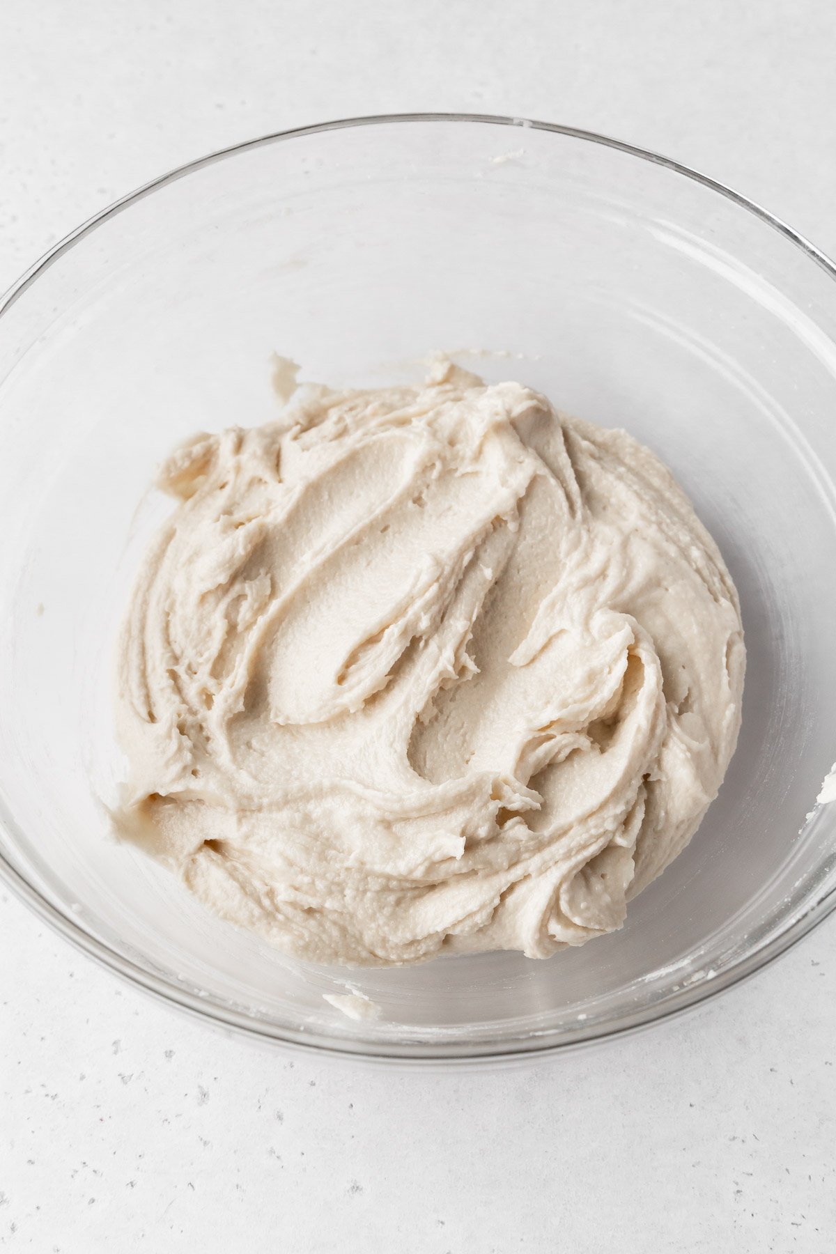 eggless pound cake batter is thick after the addition of dry ingredients.