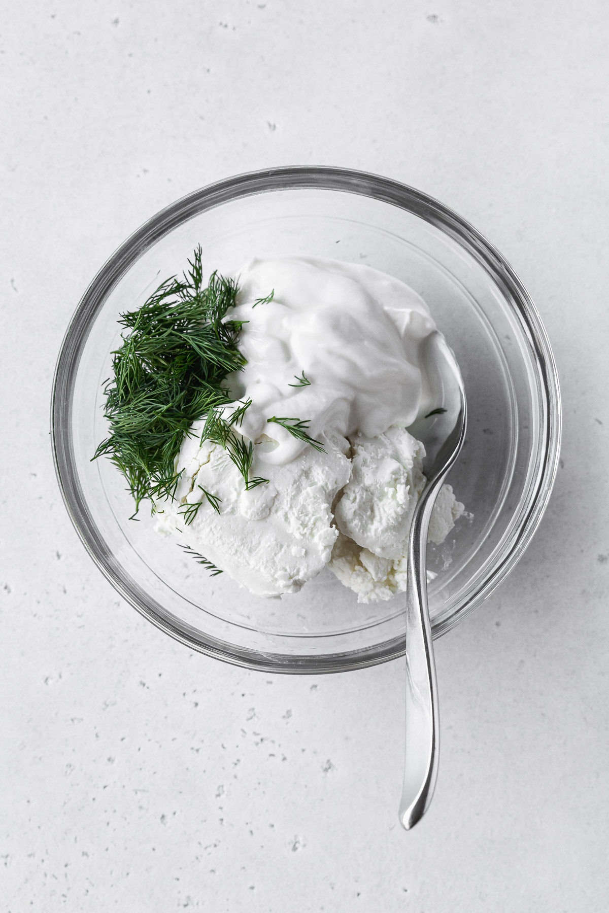 goat cheese, greek yogurt, and dill in a bowl to make spreadable goat cheese mix.