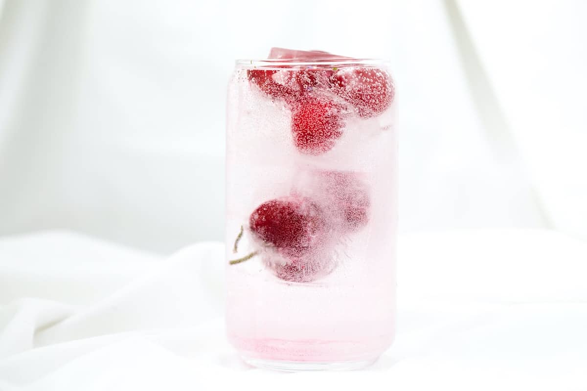 sparkling fruit infused water with cherries in the glass. photo credit karolin baitinger.