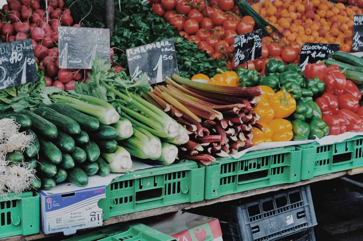 baskets of fruits and veggies set up at a farmer's market. Photo credit Ashley Winkler.