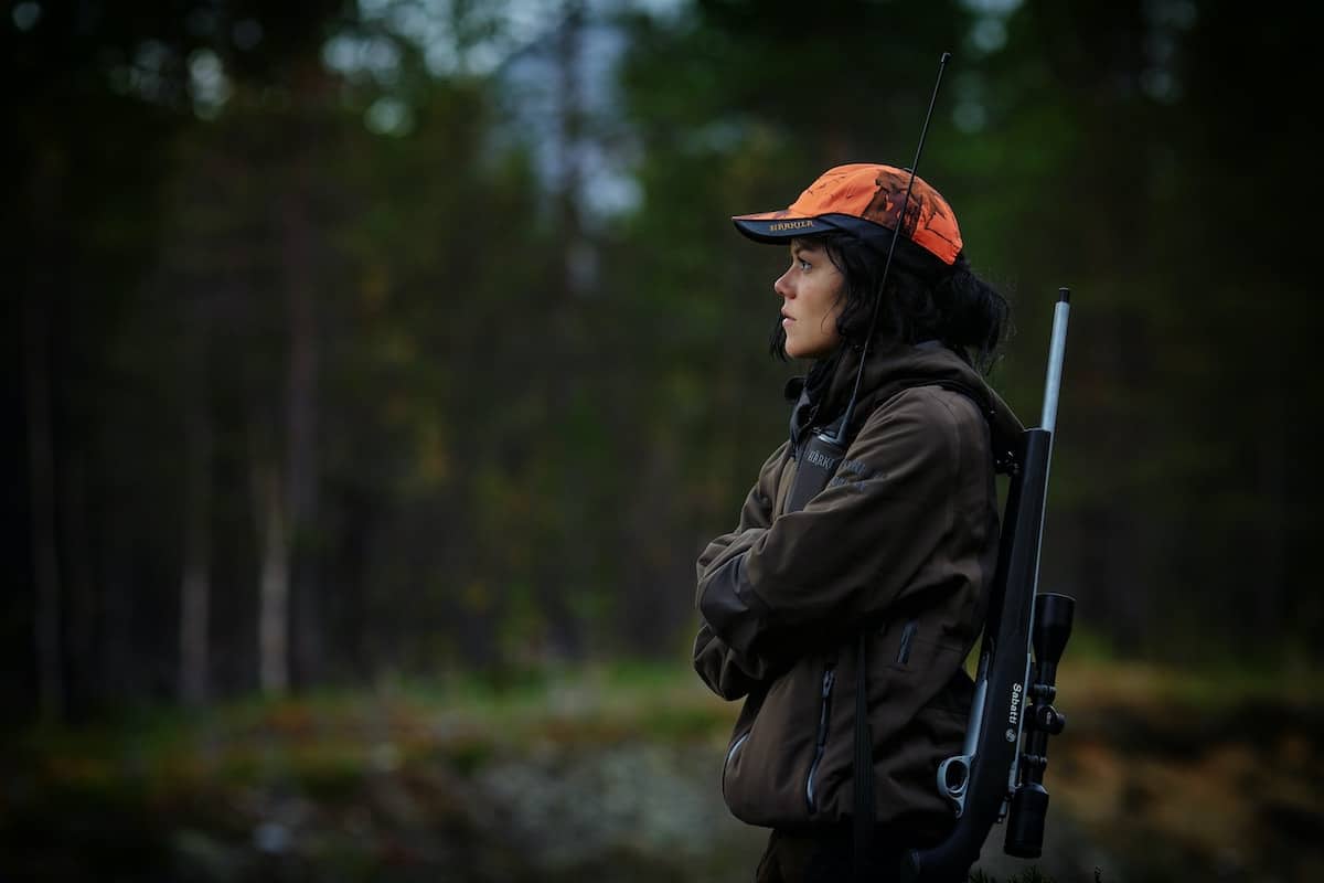 woman in hunting gear holding a rifle. Photo credit Vidar Nordli Mathisen.