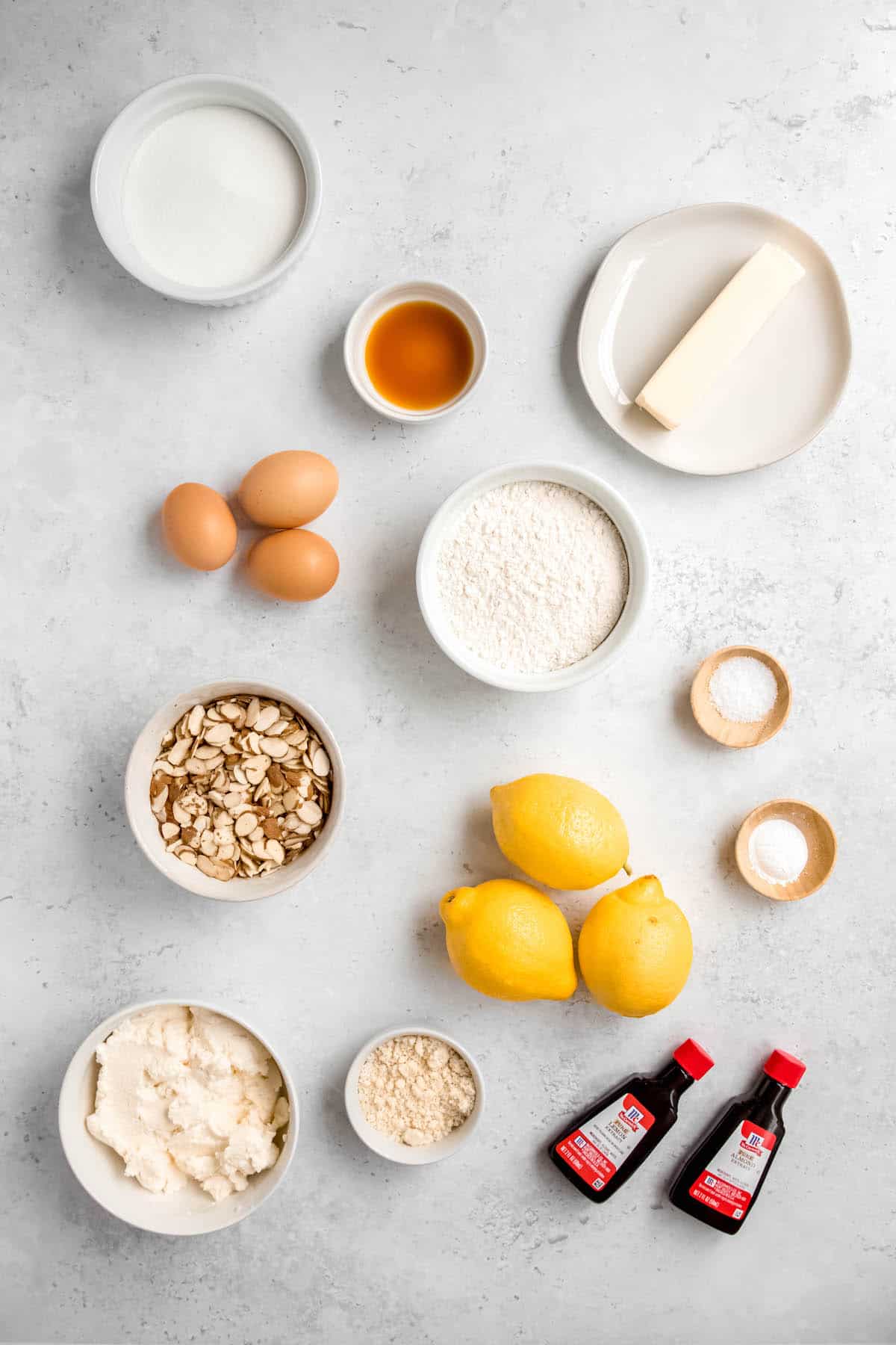 Ingredients needed to make Italian lemon ricotta cake with almond topping and lemony whipped ricotta.