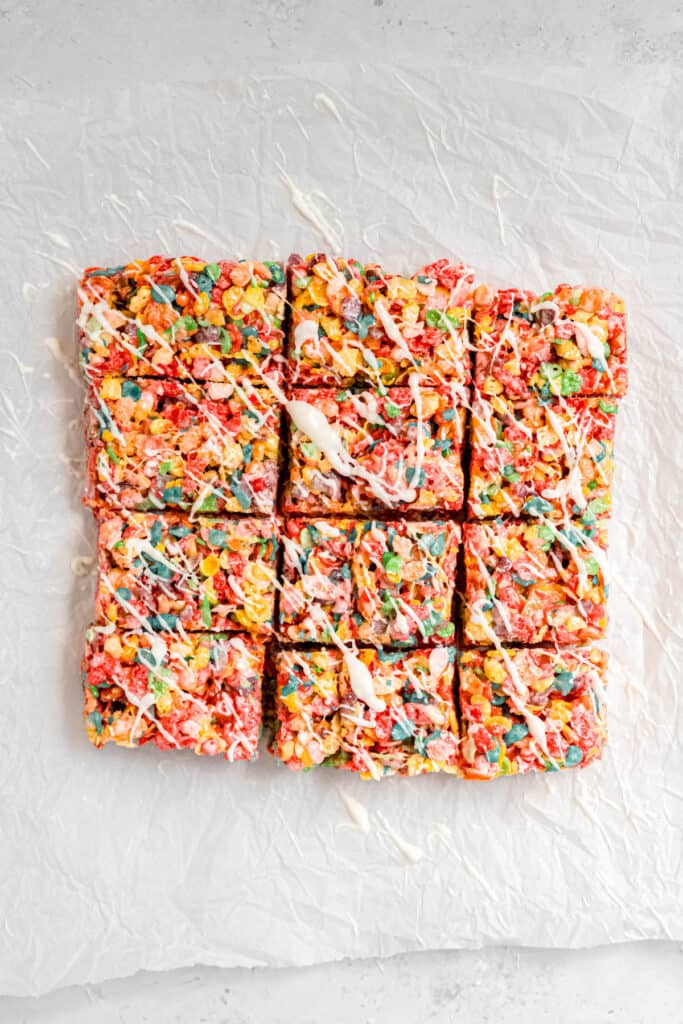 overhead shot of fruity pebbles cereal bars after decorating with a strawberry white chocolate drizzle.