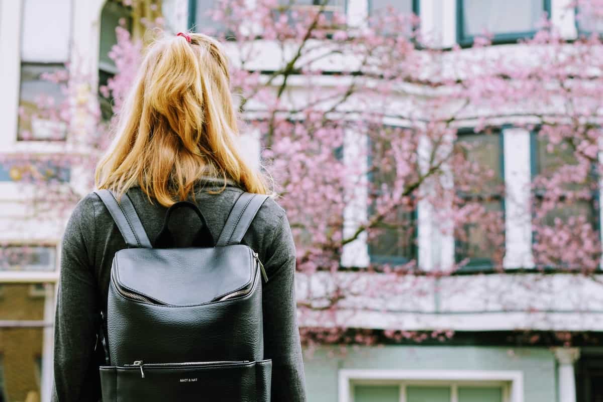 girl on a college campus staring out on the quads.