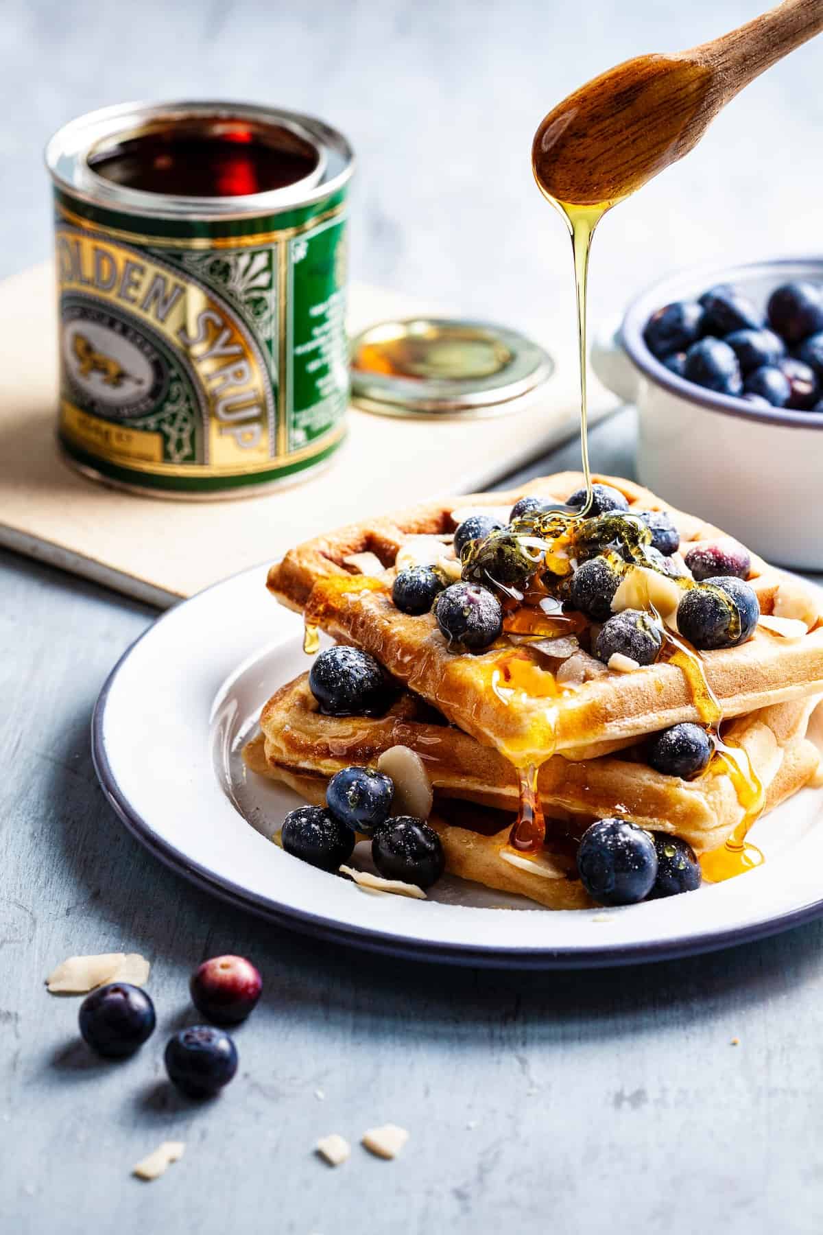 DIY frozen waffles that are plated with fresh blueberries and golden syrup.