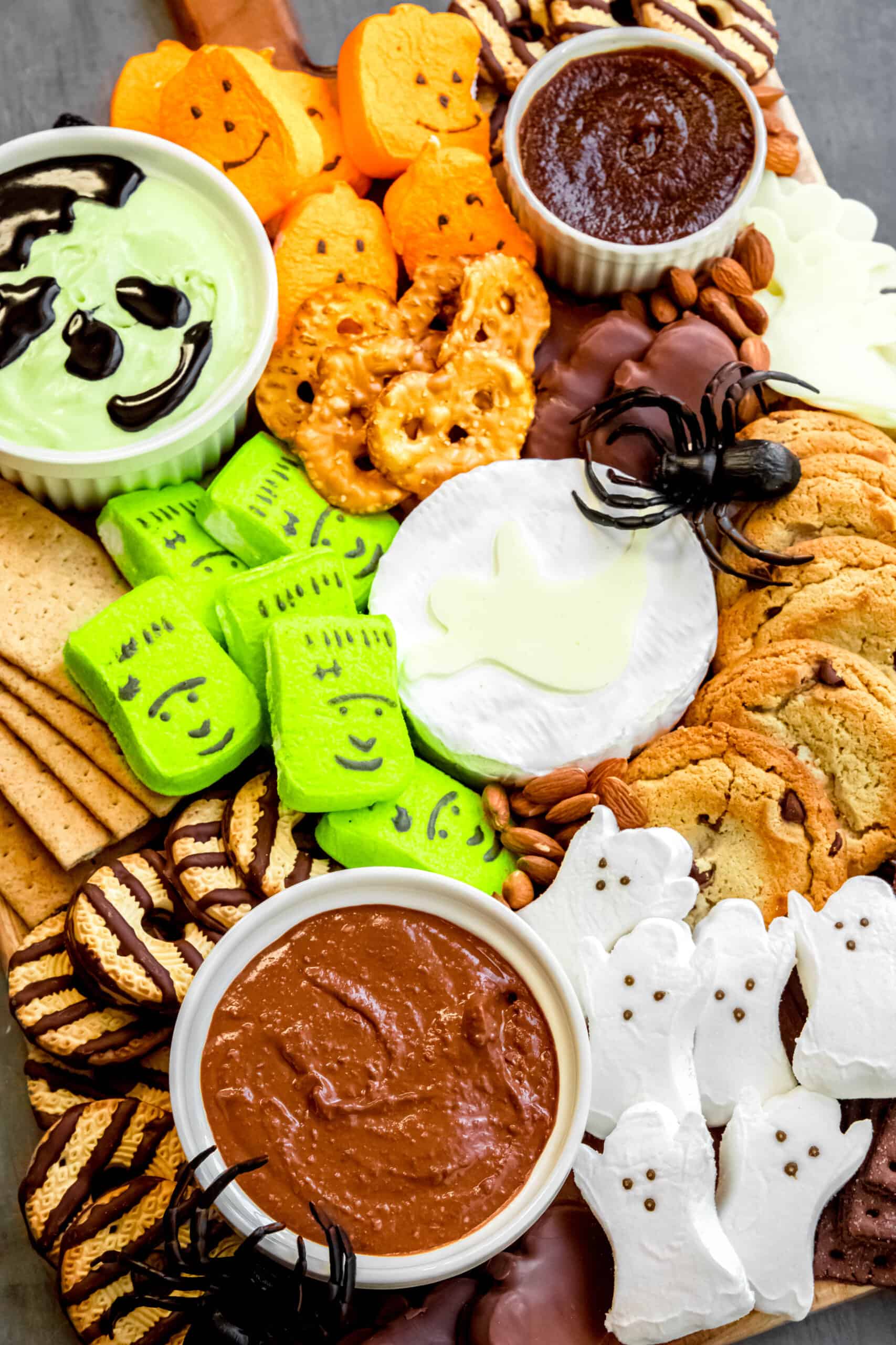 hero shot of a halloween s'mores board with candies, cookies, marshmallows, and dips.