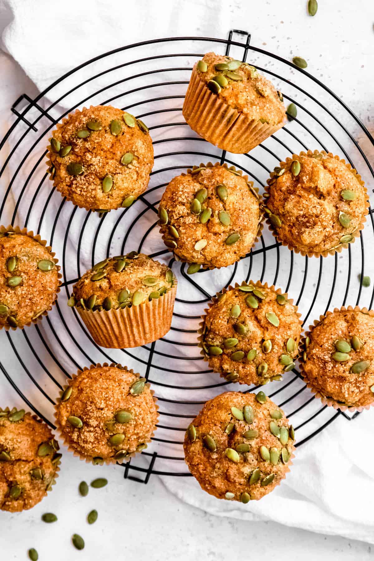 overhead hero image of high-protein pumpkin banana muffins on a cooling rack.