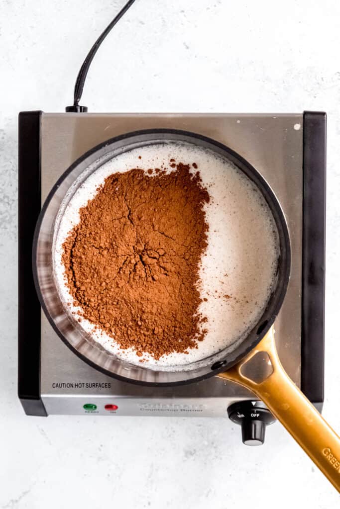 cocoa powder added to the saucepan with the freshly boiled milk mixture.