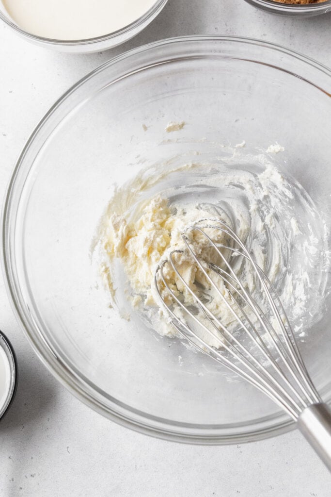 cream cheese and salt whisked together in a mixing bowl.
