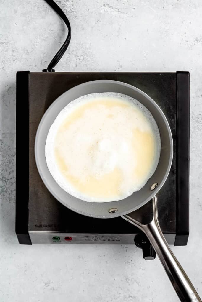 process shot showing the egg white batter being cooked in a nonstick pan.