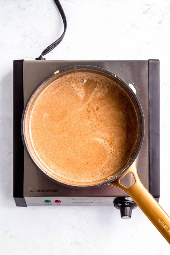 process shot - butterscotch banana pudding simmering in a saucepan.