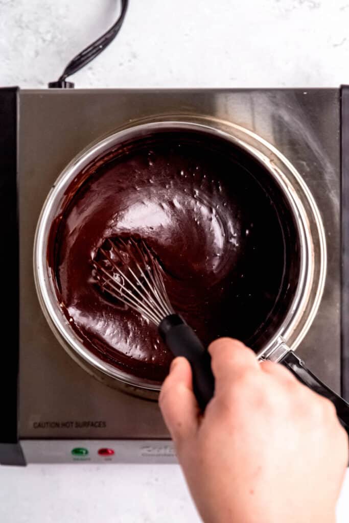 process shot - whisking the melted coffee ganache ingredients on the double boiler.