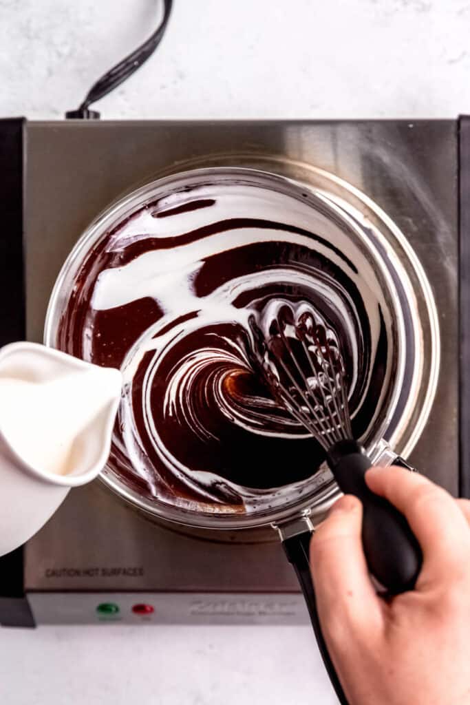 process shot - adding cream to the coffee ganache and whisking it in.