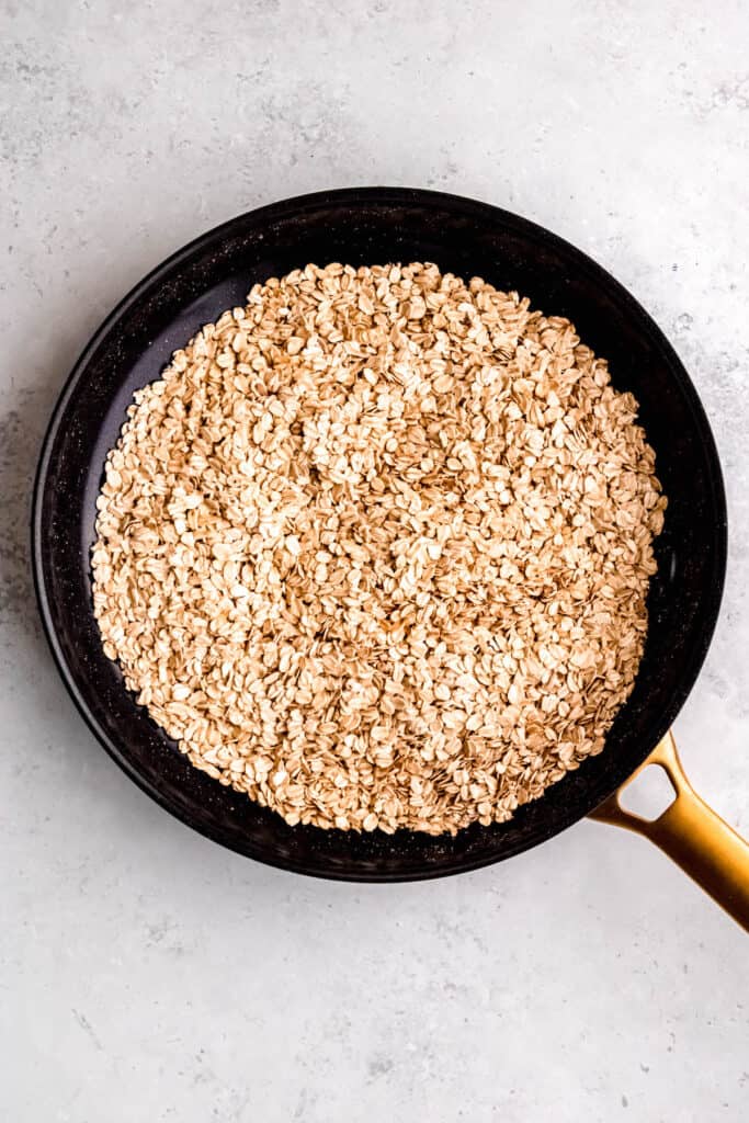 skillet with toasted rolled oats that have turned golden brown.