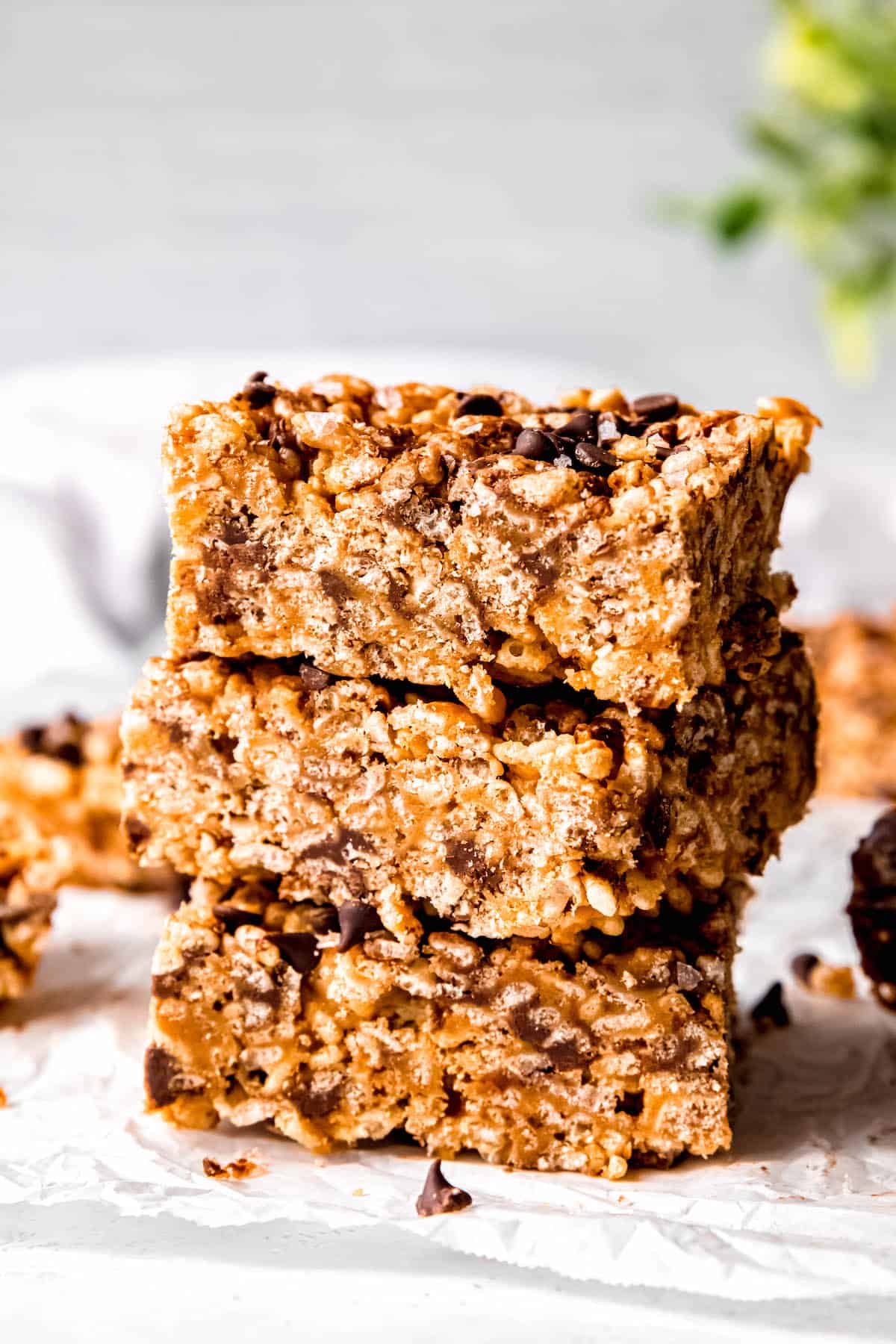 3 peanut butter rice krispies treats with chocolate chips in a stack.