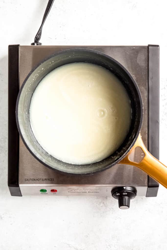 cream, sugar, and corn syrup in a saucepan coming to a boil.