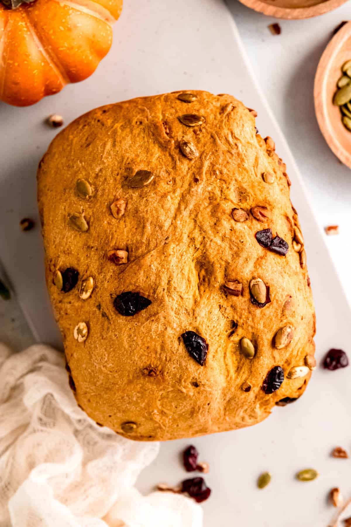 closeup shot of pumpkin machine bread on a table before slicing.