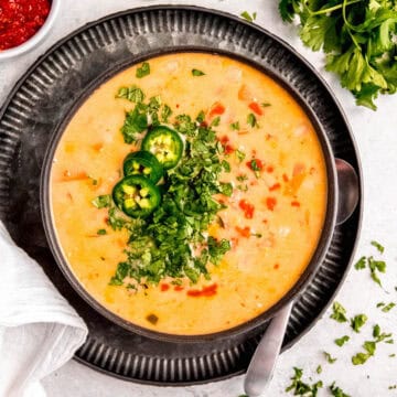 square hero shot of a bowl of sweet potato and corn vegetarian tom kha Thai soup.