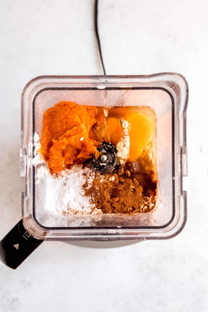 protein pumpkin pancake ingredients added to the base of a blender.