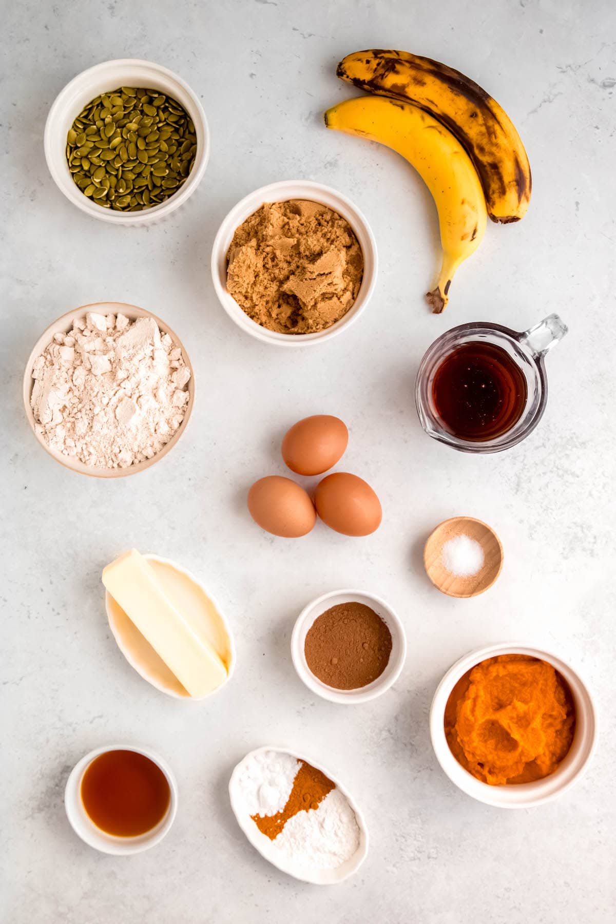 ingredients for making banana and pumpkin crumb muffins measured out on a table.