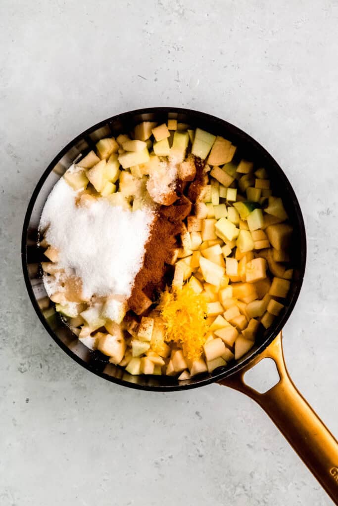 sugar, cinnamon, salt, water, apple cider vinegar, lemon juice and lemon zest added to the jam pot with the diced apples.