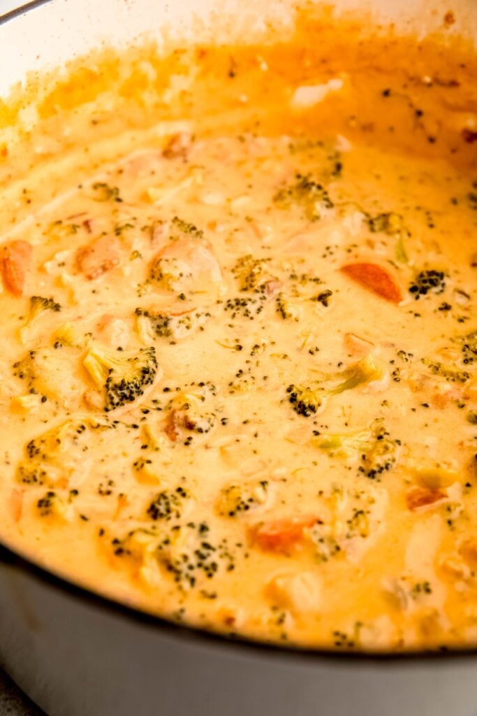45 degree angle closeup shot of bacon broccoli cheese soup in the dutch oven.