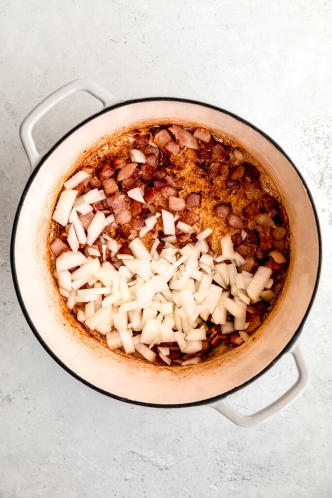 chopped onions added to the pot with the rendered bacon.