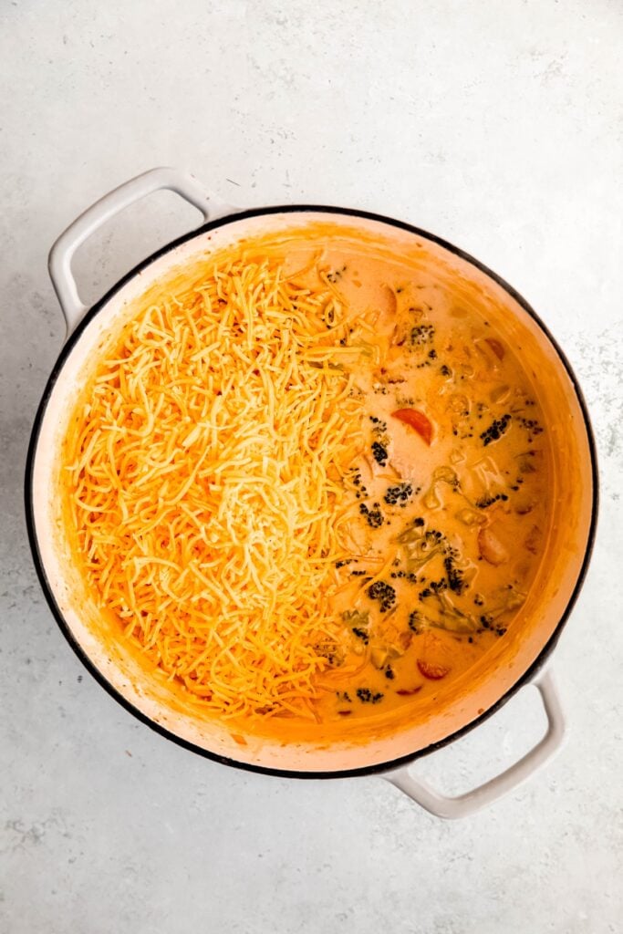 shredded cheddar cheese added to the pot with the bacon broccoli soup.