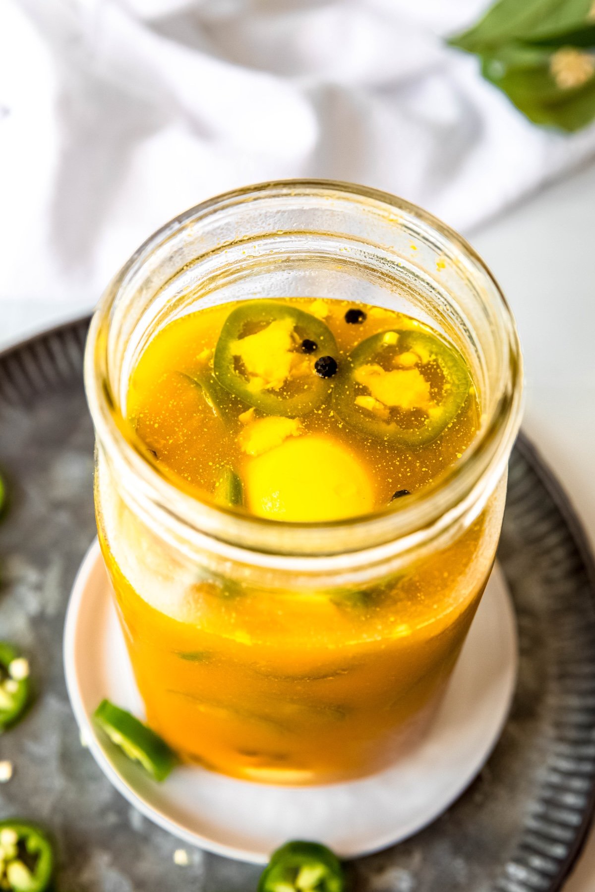 45 degree angle downward shot into a jar of spicy jalapeno pickled eggs.