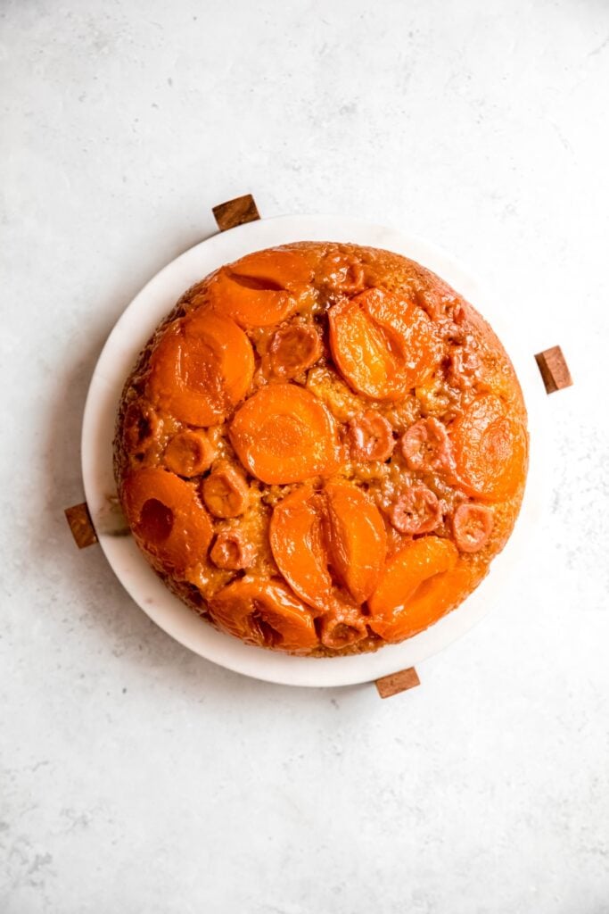 flat lay shot of the almond apricot banana upside-down cake after flipping onto a serving plate.