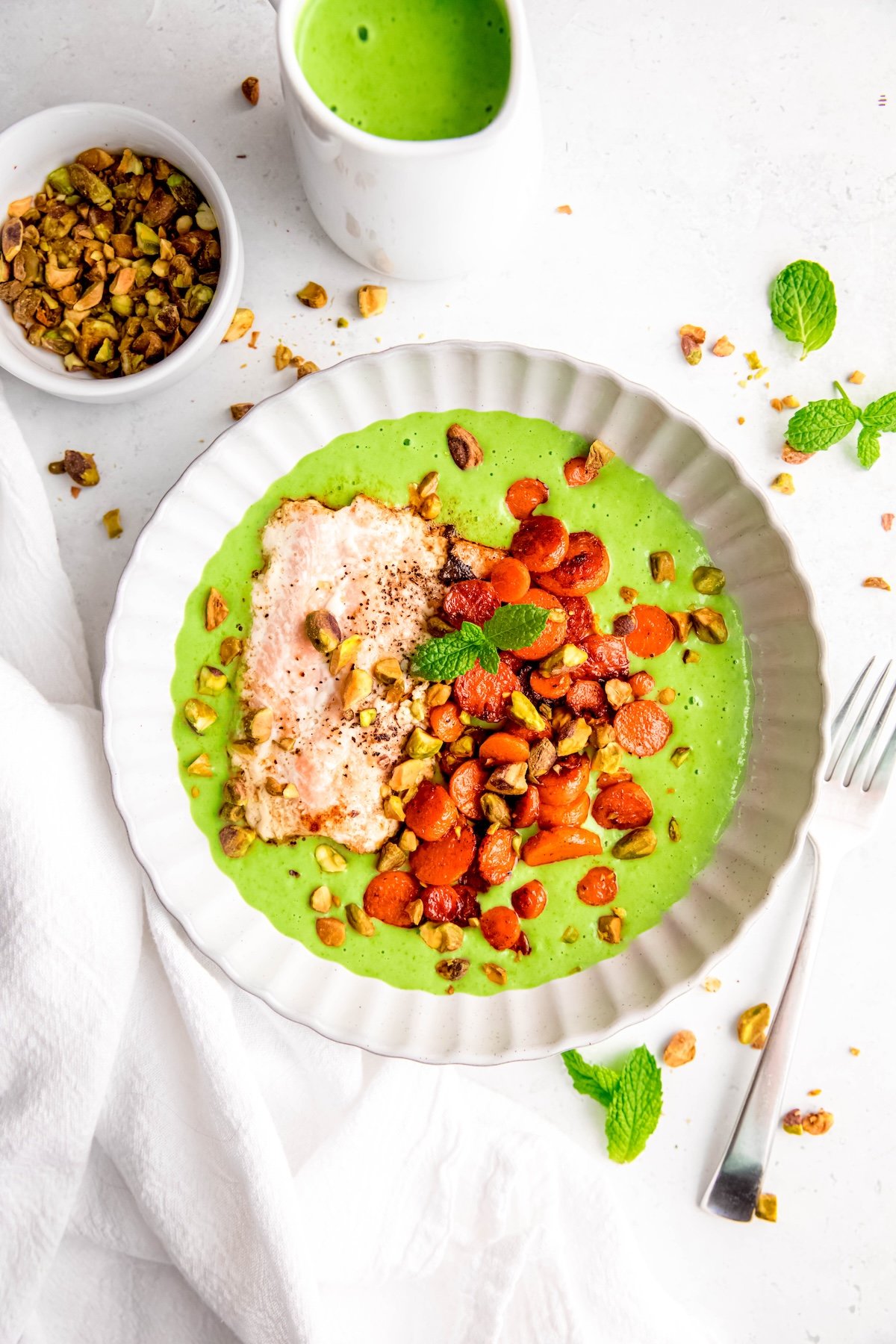 overhead shot of restaurant-style salmon with pea purée and carrots.