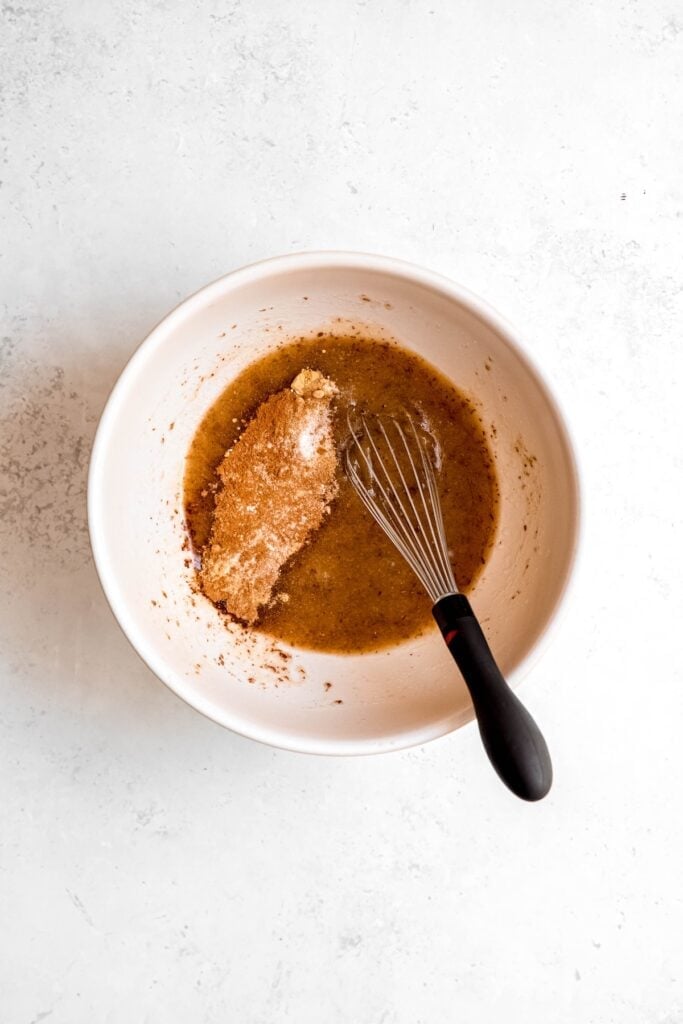baking soda, baking powder, salt, cinnamon, nutmeg, and ginger added to the bowl with the flax eggs-wet ingredients mixture.