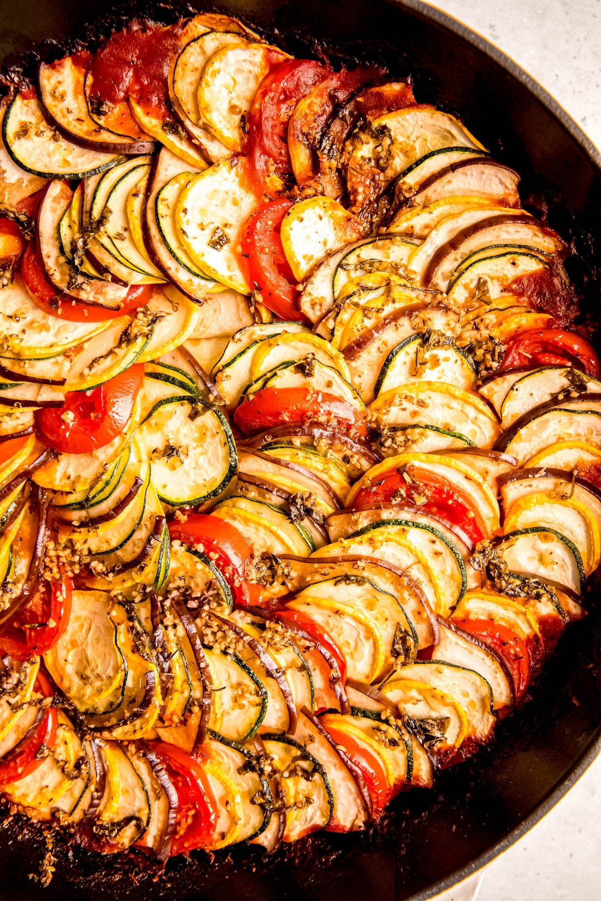 closeup shot of a skillet filled with disney-style ratatouille.